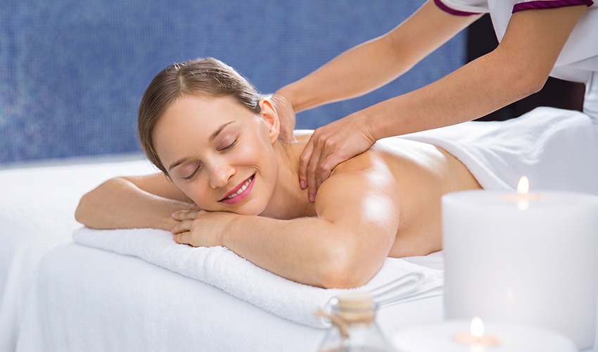 Woman enjoying a back massage at a Sydney day spa